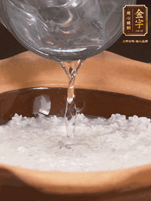 砂鍋底部刷一層油，加入大米和開水，水高1cm,大火燒開后轉(zhuǎn)中火煲5分鐘，到水微收干